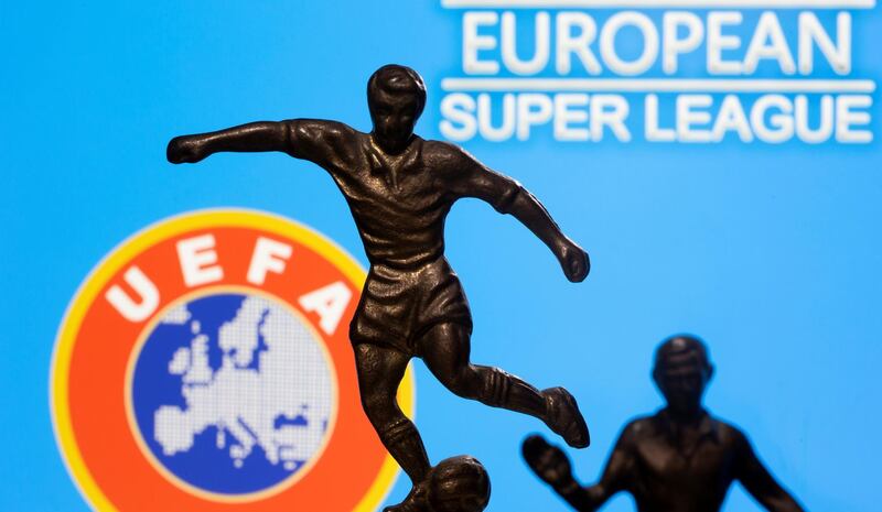 FILE PHOTO: Metal figures of football players are seen in front of the words "European Super League" and the UEFA logo in this illustration taken April 20, 2021. REUTERS/Dado Ruvic/Illustration/File Photo