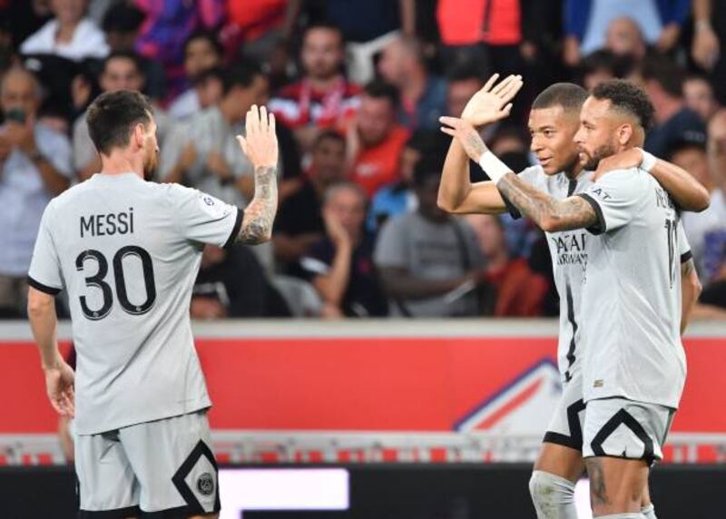 Paris Saint-Germain's French forward Kylian Mbappe celebrates with Neymar and Lionel Messi. AFP