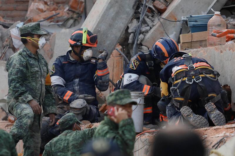 Rescue workers search for students through the rubble after an earthquake at Enrique Rebsamen school in Mexico City. Edgard Garrido / Reuters