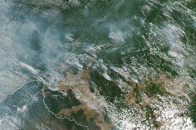 epa07783333 A handout photo made available by NASA of a satellite image showing several fires burning in the Brazilian states of Amazonas (top C-L), Para (top R), Mato Grosso (bottom R) and Rondonia (bottom C), 13 August 2019 (issued 21 August 2019). In picture at bottom left is seen Bolivia. In the Amazon region, fires are rare for much of the year because wet weather prevents them from starting and spreading. However, in July and August, activity typically increases due to the arrival of the dry season. Many people use fire to maintain farmland and pastures or to clear land for other purposes.  EPA/NASA EARTH OBSERVATORY HANDOUT  HANDOUT EDITORIAL USE ONLY/NO SALES