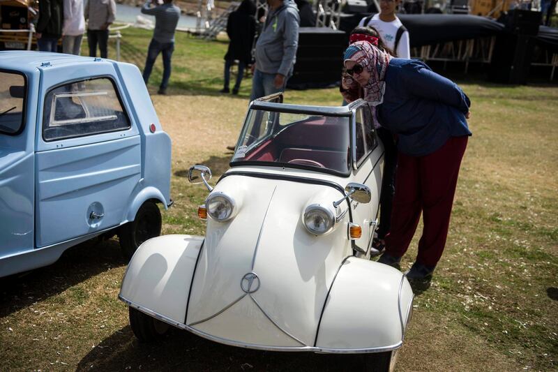 A woman looks at a classic Messerschmidt KR200 'Kabinenroller' at the 7th Cairo Classic Meet in Cairo, Egypt.  EPA
