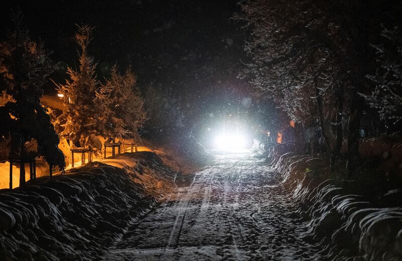 A car drives on a snow covered street in Berchtesgaden. AP