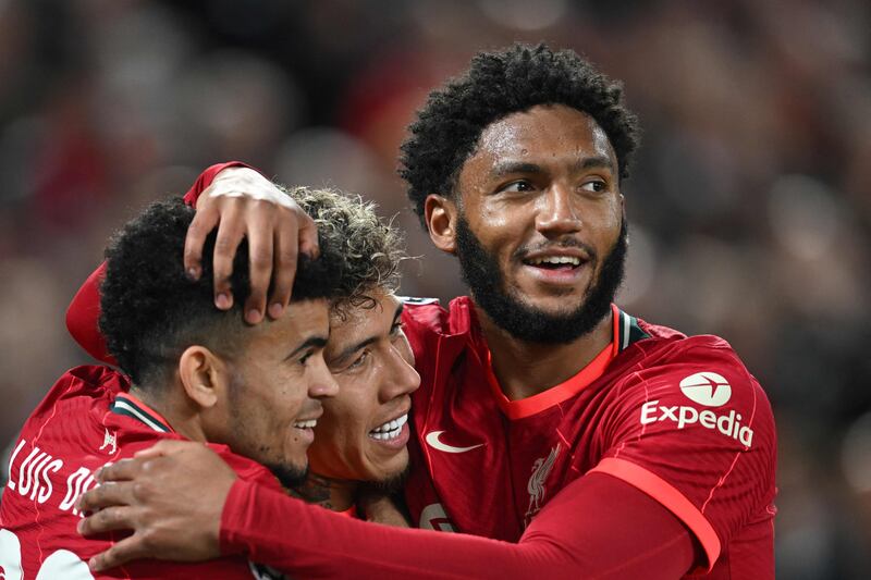 Roberto Firmino celebrates with Luis Diaz (L) and Joe Gomez after scoring the second goal. AFP