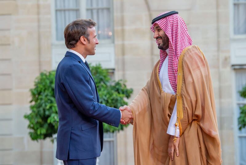 Mr Macron shakes hands with Prince Mohammed on his arrival at the Elysee Palace. 