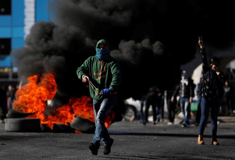 A Palestinian protester runs during clashes in response to US president Donald Trump's recognition of Jerusalem as Israel's capital. Mohamad Torokman / Reuters