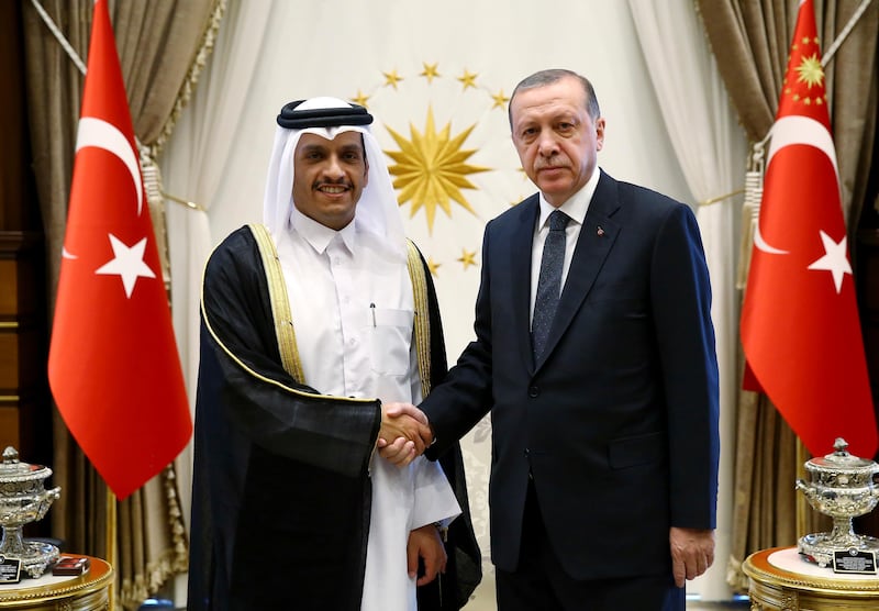 Turkey's President Recep Tayyip Erdogan, right, shakes hands with Qatar's Foreign Minister Sheikh Mohammed bin Abdulrahman Al Thani, prior to their talks at the Presidential Palace in Ankara, Turkey, Tuesday, Sept. 12, 2017.  The meeting took place amid a public row which erupted on live television between top diplomats from Qatar and four Arab nations over allegations it funds extremist groups. (Presidency Press Service via AP, Pool)