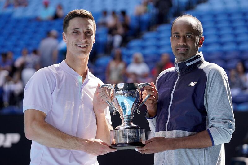 epa08186691 Joe Salisbury (L) of Britain and Rajeev Ram (R) of the USA pose for photographs after winning against Luke Saville and Max Purcell of Australia during the Men's Doubles final on day 14 of the Australian Open tennis tournament in Melbourne, Australia, 02 February 2020.  EPA/MICHAEL DODGE EDITORIAL USE ONLY AUSTRALIA AND NEW ZEALAND OUT