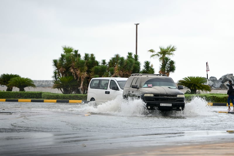 Drivers navigate a flooded motorway in Fujairah. Khushnum Bhandari / The National