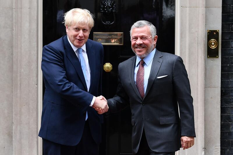 Britain's Prime Minister Boris Johnson (L) greets King Abdullah II of Jordan outside 10 Downing Street in London on August 7, 2019, ahead of bilateral talks and a working lunch. / AFP / Daniel LEAL-OLIVAS

