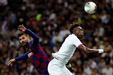 Chelsea's Tammy Abraham, right, gets the better of Barcelona's Gerard Pique. AP Photo