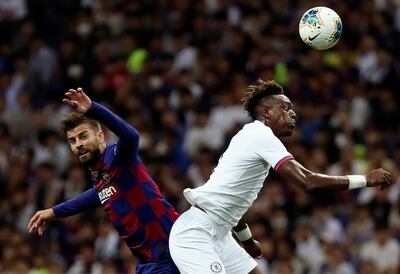 Barcelona's Gerard Pique, left, and Chelsea's Tammy Abraham, right, compete for the ball during a friendly soccer match between FC Barcelona and Chelsea FC in Saitama, north of Tokyo, Tuesday, July 23, 2019. Chelsea won 2-1. (AP Photo/Eugene Hoshiko)