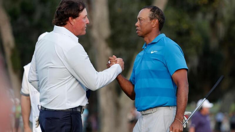 In this May 10, 2018, file photo, Phil Mickelson, left, and Tiger Woods shake hands after the first round of the Players Championship golf tournament, in Ponte Vedra, 2018. AFP