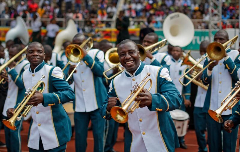 Members of a military band dances as they wait for the arrival of the new president. Ben Curtis / AP Photo