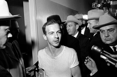 Lee Harvey Oswald, surrounded by detectives, talks to the media at the Dallas police station, on November 23, 1963, in connection with the assassination of John F Kennedy. AP