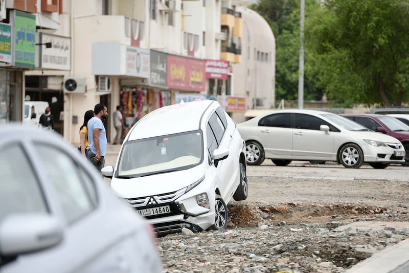 A car swept into a ditch by floodwaters in Fujairah.  Khushnum Bhandari / The National
