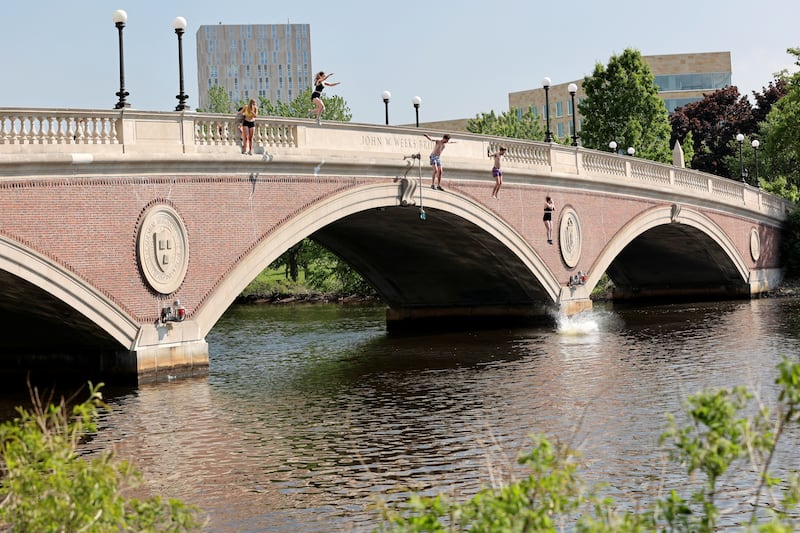 Harvard 2022 graduates jump into the Charles River amid the US heatwave. Reuters