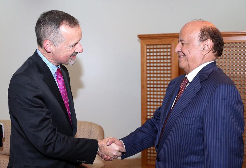 Yemen's President Abd-Rabbu Mansour Hadi (R) shakes hands with the newly-appointed British ambassador to Yemen Edmund Fitton-Brown in the southern port city of Aden March 3, 2015. Hadi has resumed official duties from southern Yemen's main city, where he fled last month after Houthi fighters put him under house arrest in Sanaa when they stormed his private residence and the presidency compound in January. REUTERS/Stringer (YEMEN - Tags: POLITICS CIVIL UNREST)