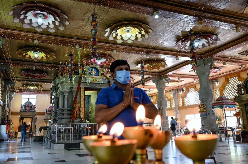 A Hindu devotee offers prayers during Diwali, the Hindu festival of lights, at a temple in Colombo.  AFP