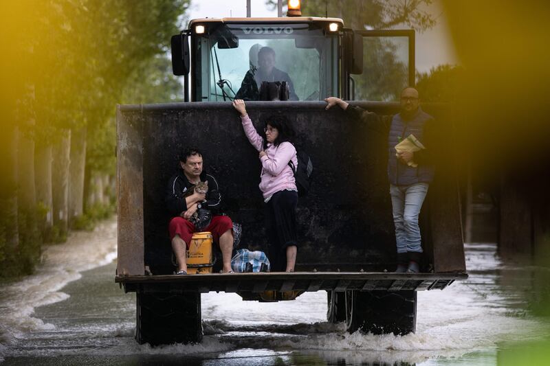Residents are rescued on a digger in Massa Lombarda. AFP