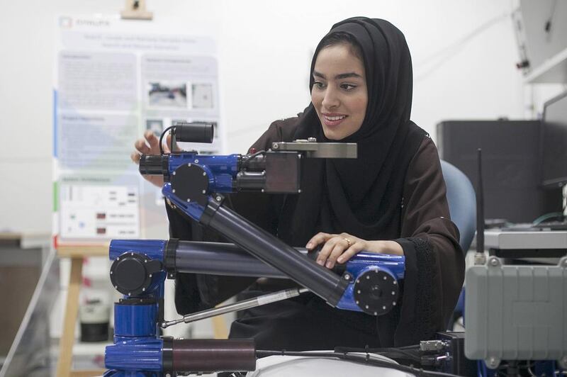 Maha Al Ajmi demonstrates her robotic project for use in retrieving samples from search-and-rescue scenarios. Mona Al Marzooqi / The National 