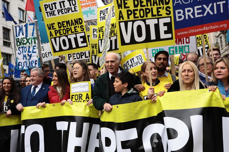 Leader of the Liberal Democrats Sir Vince Cable MP (C) and Conservative MP Justine Greening (R) join protesters. Getty Images