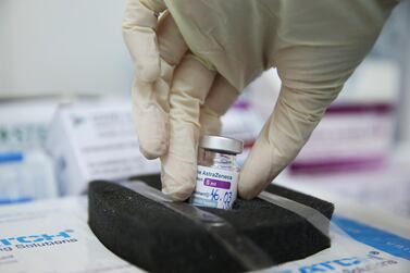 A medical worker holds a vial with the AstraZeneca coronavirus disease vaccine at a hospital in Tbilisi, Georgia. Reuters