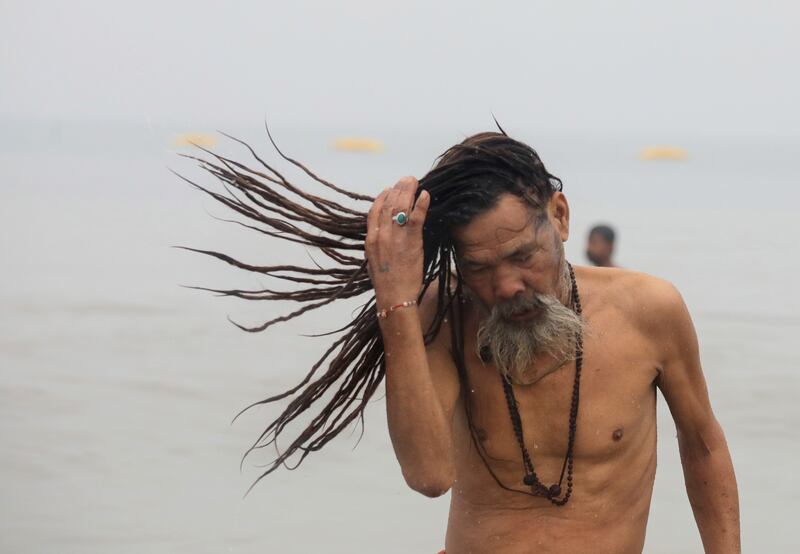A monk takes a holy dip on the second day of Ganga Sagar. EPA