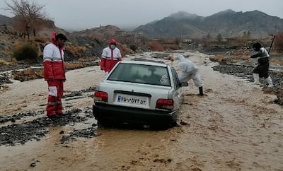 Rescue workers assisting a vehicle stuck in floods in Hormozgan Province in southern Iran. AFP 