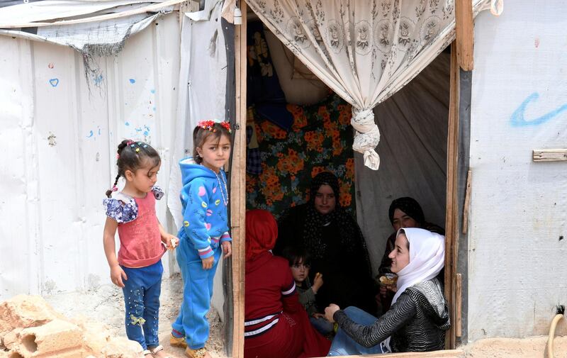 Syrian refugee women sit together in a tent at the Lebanese border town of Arsal, Lebanon. Reuters