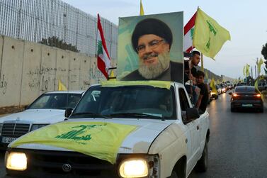 Hezbollah vehicles parade in the streets. Reuters  