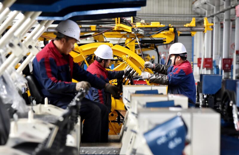 Employees work on a drilling machine production line at a factory in Zhangjiakou, Hebei province, China November 14, 2018. REUTERS/Stringer  ATTENTION EDITORS - THIS IMAGE WAS PROVIDED BY A THIRD PARTY. CHINA OUT.