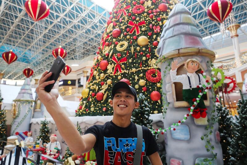 Dubai, United Arab Emirates - December 21st, 2017: Visitors at the Christmas lights at Wafi Mall. Thursday, December 21st, 2017 at Wafi Mall, Dubai. Chris Whiteoak / The National