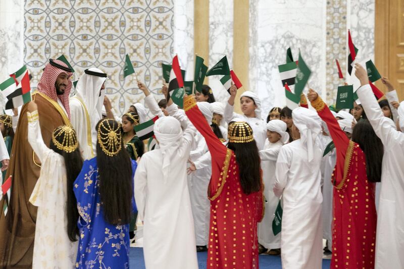 ABU DHABI, UNITED ARAB EMIRATES - November 27, 2019: School children welcome HRH Prince Mohamed bin Salman bin Abdulaziz, Crown Prince, Deputy Prime Minister and Minister of Defence of Saudi Arabia (L) and HH Sheikh Mohamed bin Zayed Al Nahyan, Crown Prince of Abu Dhabi and Deputy Supreme Commander of the UAE Armed Forces (2nd L), during a state visit at Qasr Al Watan. 

( Eissa Al Hammadi for Ministry of Presidential Affairs )
---