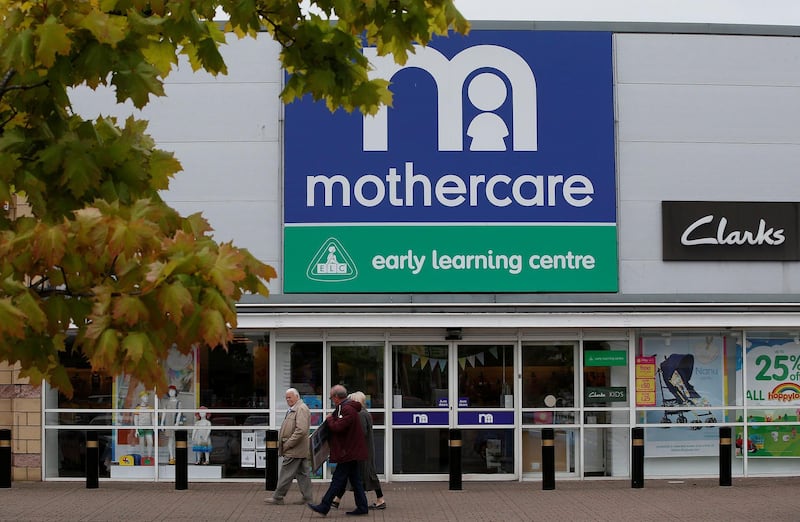 People walk past a Mothercare store in Altricham, Britain, May 16, 2018. REUTERS/Andrew Yates