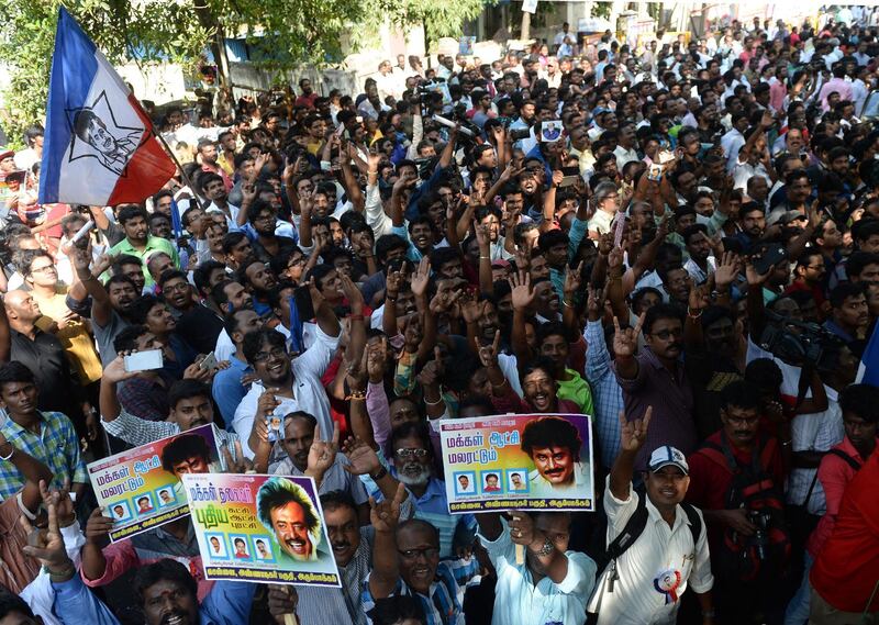 Indian fans of Rajinikanth celebrate after his announcement that he will enter into politics. Arun Sankar / AFP