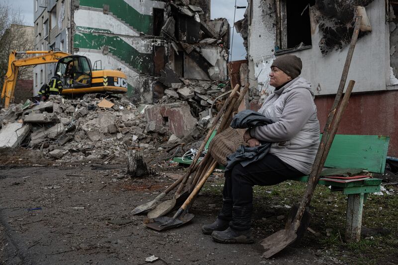A Ukrainian woman in Borodianka waits as rescue workers search for her daughter, her son-in-law and her granddaughter among the rubble. Getty Images
