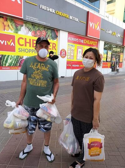 Filipino residents collect food parcels supplied by volunteers from a Dubai badminton group. Courtesy: Dubai Badminton Together Against Covid 19