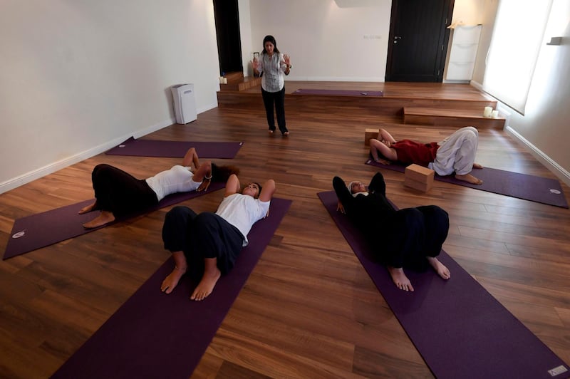Nouf Marwaai, 38, the head of the Arab Yoga Foundation (background) instructs a yoga class at her studio in the western Saudi Arabian city of Jeddah on September 7, 2018.  Widely perceived as a Hindu spiritual practice, yoga was not officially permitted for decades in Saudi Arabia, but with Crown Prince Mohammed bin Salman vowing an "open, moderate Islam", the kingdom last November recognised yoga as a sport. Photo / AFP