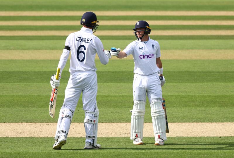 England opening batsman Zak Crawley and Ollie Pope touch gloves. Getty