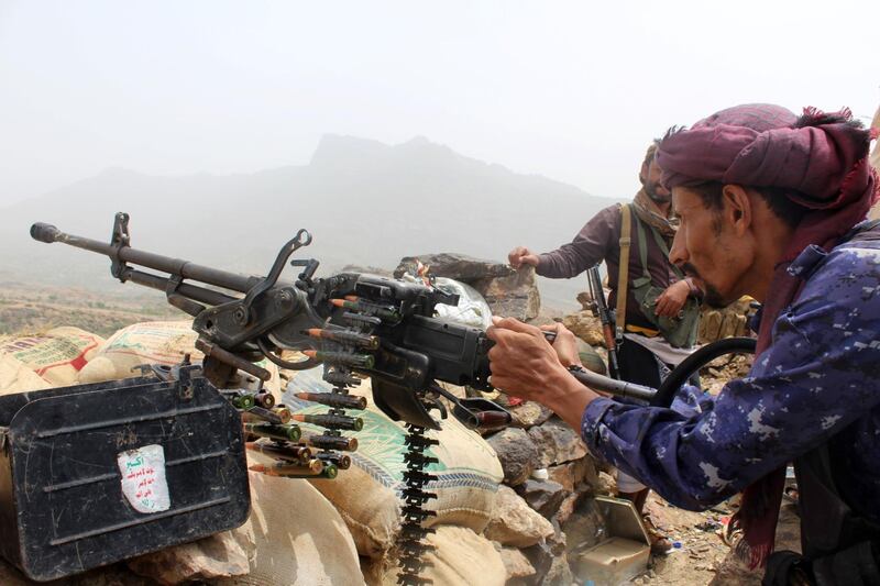 A Yemeni pro-government fighter fires a heavy machine gun as Emirati supported forces take over Huthi bases on the frontline of Kirsh between the province of Taez and Lahj, southwestern Yemen, on July 1, 2018. The United Arab Emirates on Sunday announced it had halted the offensive it is backing against Huthi rebels in Yemen's port city of Hodeida to give a chance to UN diplomatic efforts.
 / AFP / Saleh Al-OBEIDI
