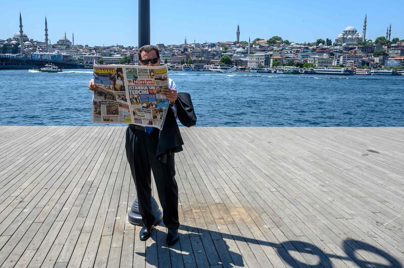 A man reads a daily after the Istanbul mayoral elections re-run, at Karakoy in Istanbul.
 AFP