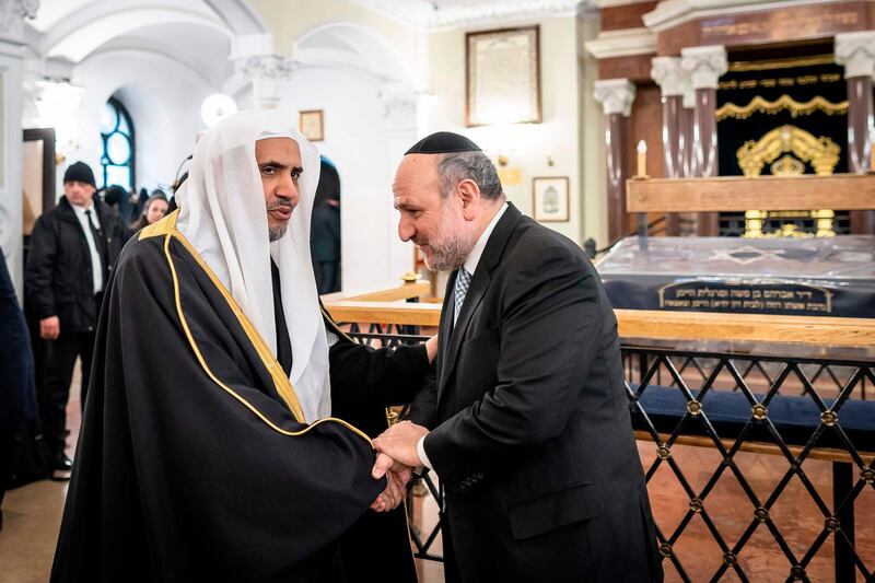 Secretary General of the Muslim World League Mohammad Abdulkarim al-Issa shakes hands with Poland's Chief Rabbi Michael Schudrich (R) during his visit to the Nozyk Synagogue in Warsaw.  AFP