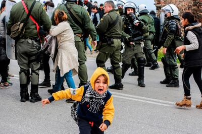 A young migrant reacts during clashes with riot police as refugees and migrants demonstrate outside the Kara Tepe camp, on the island of Lesbos, on February 3, 2020.  Riot forces used tear gas on the Greek island of Lesbos on Monday against asylum seekers, two thousand of whom demonstrated against the new law tightening asylum procedures in Greece, we learned from police sources.  / AFP / Manolis Lagoutaris
