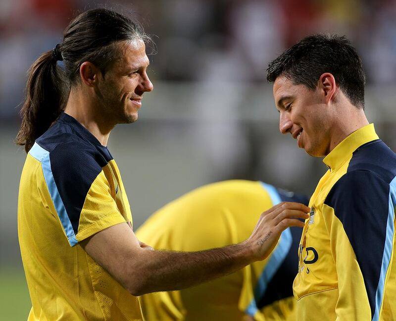 Martin Demichelis, left, talks with Samir Nasri, right, during Manchester City's training session on Wednesday in Abu Dhabi. Satish Kumar / The National / May 14, 2014