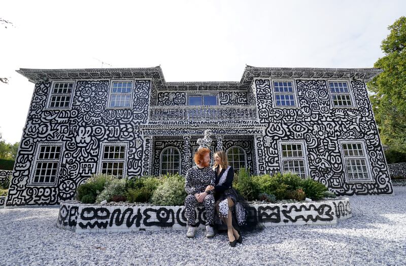 Sam Cox and his wife Alena outside the Doodle House. 