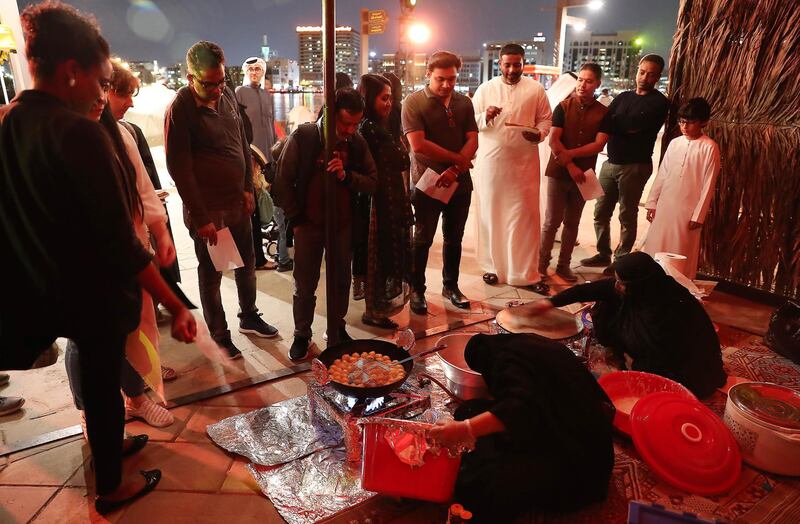 DUBAI, UNITED ARAB EMIRATES, Jan 09  – 2020 :- Visitors watching the making of UAE traditional dishes at the Al Shindagha Days culture festival held at Al Shindagha Heritage District in Dubai. (Pawan Singh / The National) Photo essay for Weekend. Story by Katy Gillett 