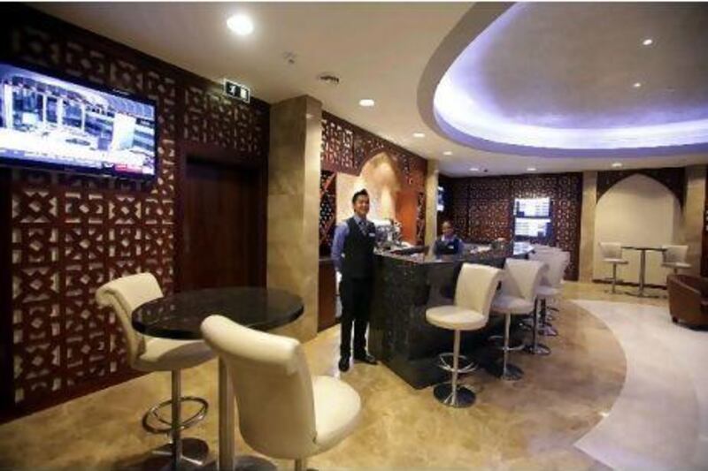 Guests can nibble hors d'oeuvres and play video games in the new business lounge at Abu Dhabi Airport's Terminal 1.