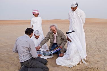 The artist Christo Yavacheff, centre, meets with Liwa residents Khalfan Al Qubasi, left, Saeed Al Falahi, right, and Obaid Al Mazrouei, front right, in October 2012, to discuss his plans to construct The Mastaba, a pyramid of 410,000 barrels. Antonie Robertson / The National