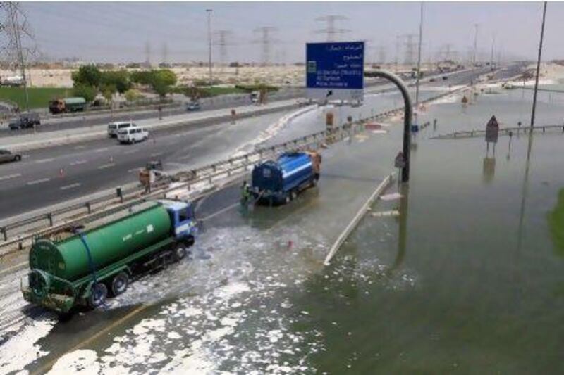 Lorries negotiate a flooded Al Khail road in Dubai.