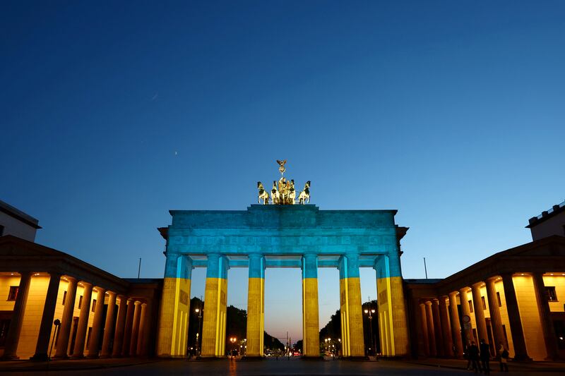 The Brandenburg Gate illuminated in the colours of the Ukrainian flag in May - ironic, given the gas shortage stoked by Russia's invasion of Ukraine has prompted the dimming of lights in public buildings in Germany. Reuters